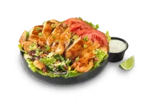 A bowl of honey BBQ chicken salad topped with grilled chicken pieces, fresh greens, tomatoes, and a side of dressing, priced at $11.99 with 910 calories.