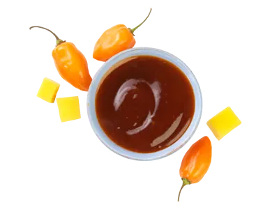 Mango habanero sauce with glossy texture combining sweet mango and spicy heat