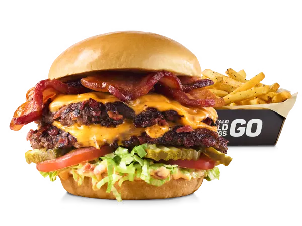 Large cheeseburger stacked with multiple strips of crispy bacon and beef patties